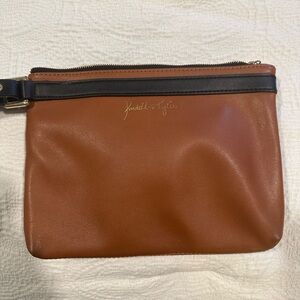 Kendall & Kylie Brown wristlet with black detail, adjustable strap.